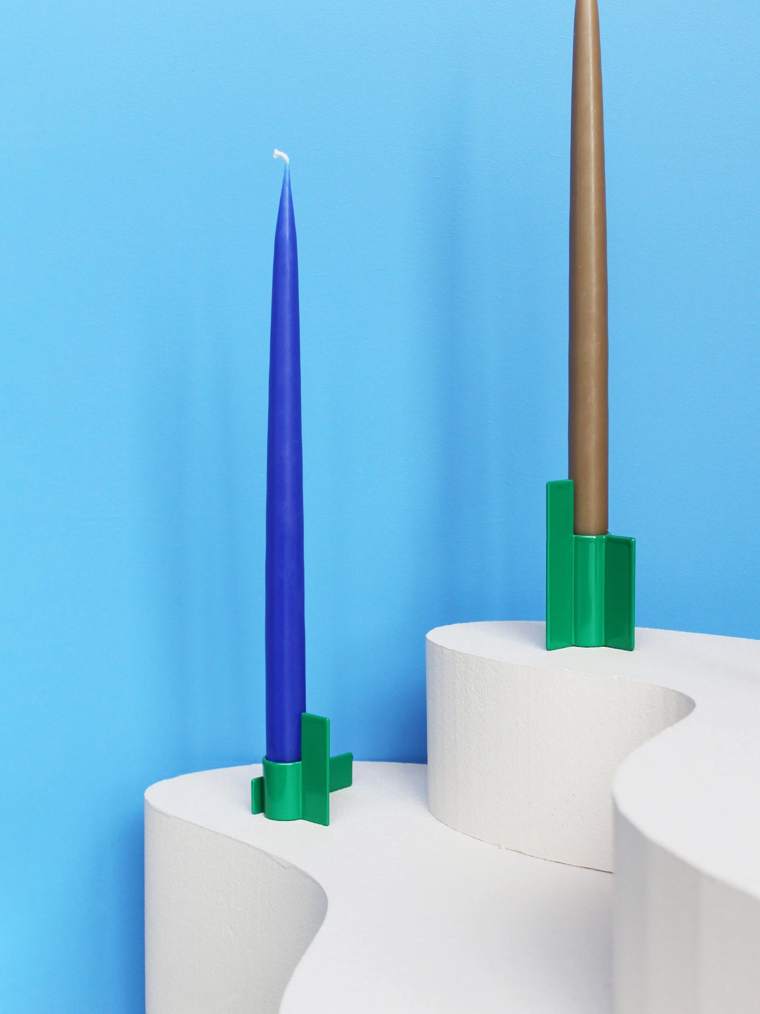 Modern green candlestick from the Stences Icon series, crafted in stainless steel with a sharp, graphic silhouette.