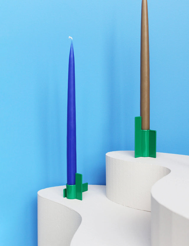 Modern green candlestick from the Stences Icon series, crafted in stainless steel with a sharp, graphic silhouette.
