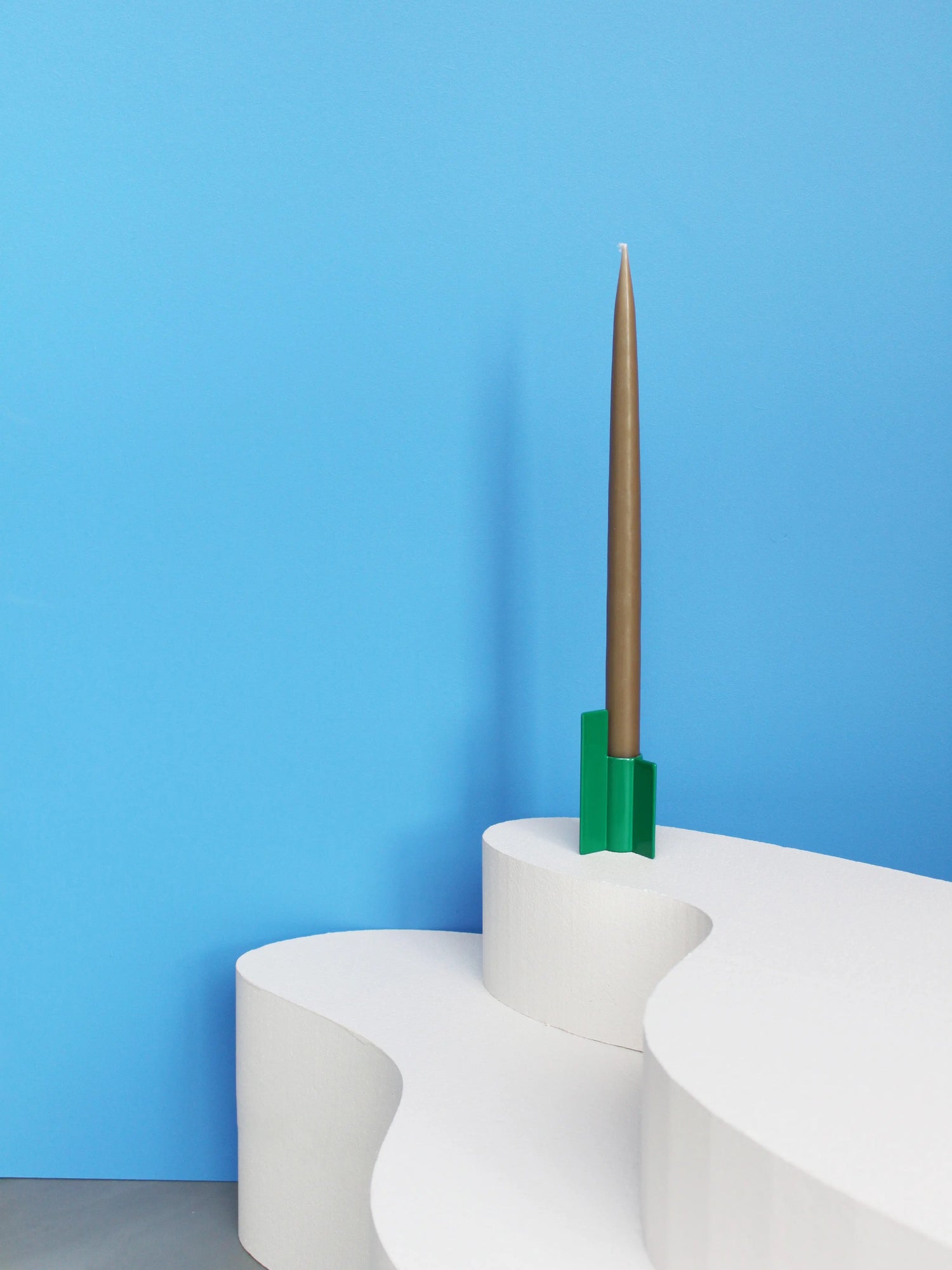 Modern green candlestick from Stences, with a minimalist design and a sharp, graphic silhouette.