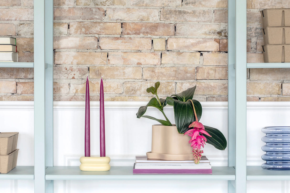 Soft pastel yellow ceramic candlestick designed for versatile styling with other colorful or neutral decor