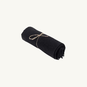 Black linen tablecloth on a dining table, enhancing the sophistication and elegance of the setting
