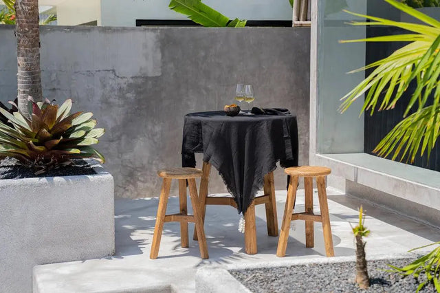 Close-up of the luxurious texture of the black linen tablecloth, showcasing its quality and fine craftsmanship
