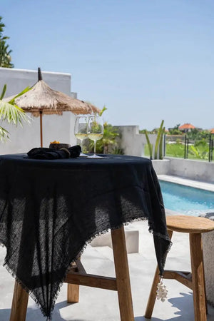 Black linen tablecloth paired with matching napkins, creating a refined and stylish dining setting.