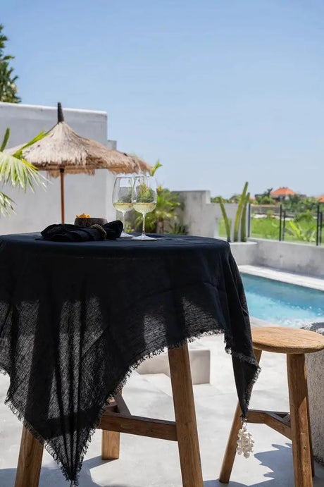 Black linen tablecloth paired with matching napkins, creating a refined and stylish dining setting.