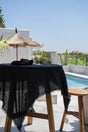 Black linen tablecloth paired with matching napkins, creating a refined and stylish dining setting.