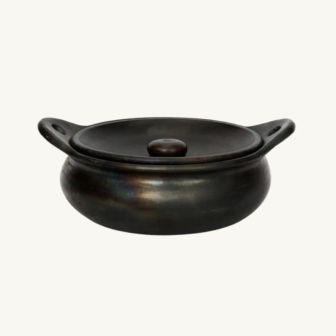 Sophisticated black burnt terracotta serving pot with lid, perfect for stylish dining and entertaining