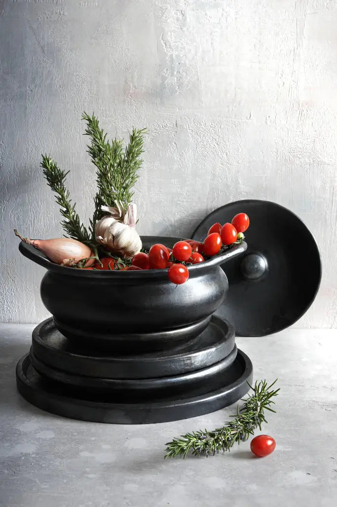 Black burnt terracotta serving pot styled in a modern dining table setup, perfect for both casual and formal meals