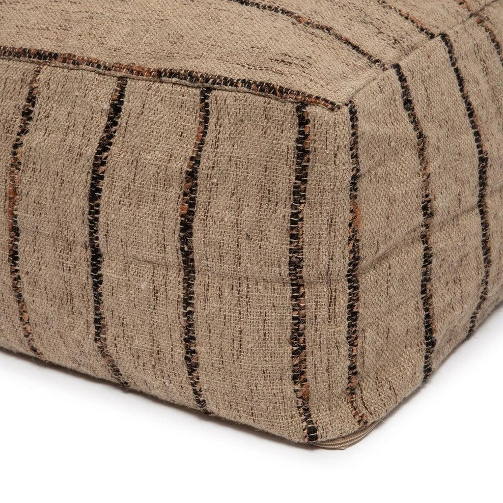 'The Oh My Gee' Pouffe styled with natural decor elements, showcasing its beige and black bohemian pattern.