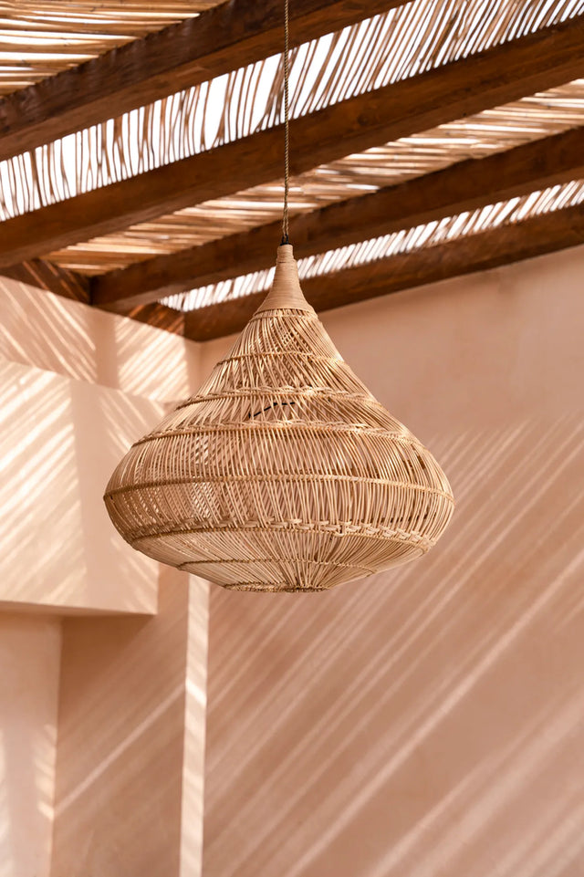 Stylish rattan lampshade with intricate patterns, ideal for creating atmospheric lighting in any space