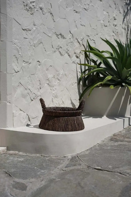 Chizara Mand Basket in a rustic interior, blending its warm natural tones with traditional decor elements.