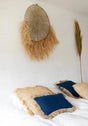 Soft cotton cushion cover in blue, adorned with raffia fringes, perfect for creating a cozy, boho vibe