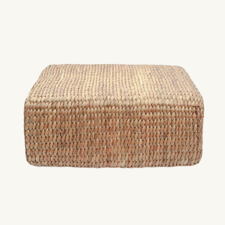 Handwoven hyacinth square pouffe in natural color, offering bohemian elegance and eco-conscious craftsmanship to any living space