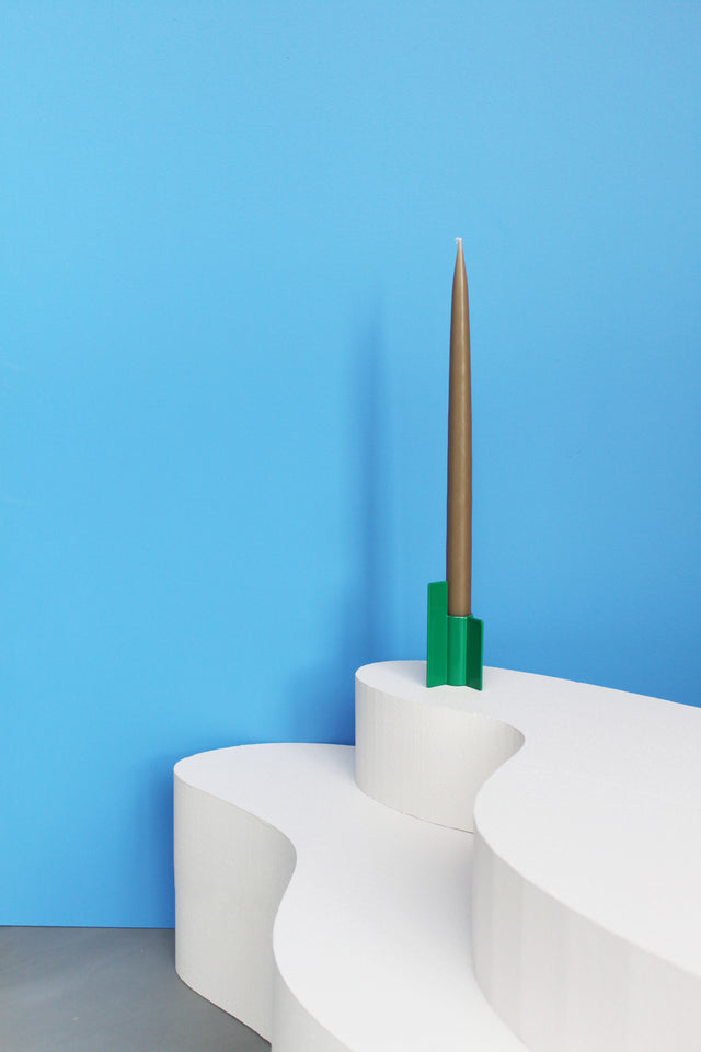 Modern green candlestick from Stences, with a minimalist design and a sharp, graphic silhouette.