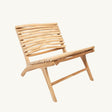 The Islander Essence Chair, handcrafted from high-quality teak wood, offers an elegant and durable seating solution for gardens, patios, and covered outdoor spaces