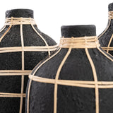 The Large Whoopy Vase in natural black terracotta and rattan detail adds a warm, textured touch to your living room, bathroom, or outdoor area