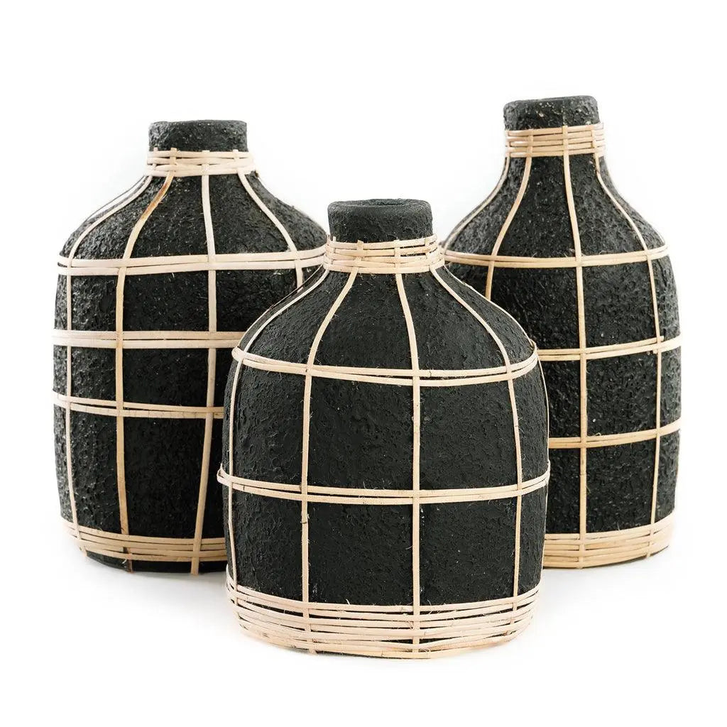 Featuring a sleek curved design and rattan accents, the Large Whoopy Vase is perfect for showcasing dried flowers and enhancing any coastal-themed decor