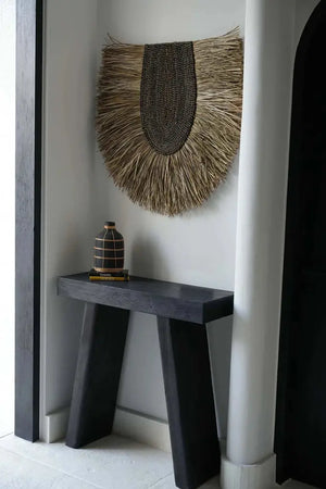 The Large Whoopy Vase, with its natural black terracotta finish and rattan detailing, creates a refined coastal ambiance for any room or covered outdoor area