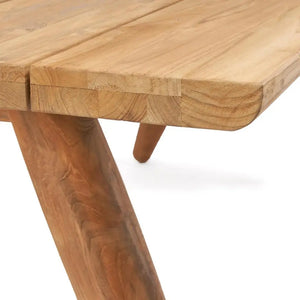 Close-up of the Matita Dining Table, highlighting the bold legs and smooth, sleek tabletop. Crafted with eco-friendly materials, this modern piece blends style with durability.