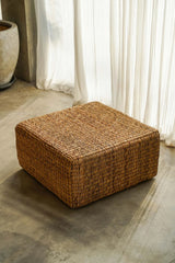 Boho-inspired square pouffe made from natural hyacinth fibers, offering durability and artisanal charm for any room or décor style