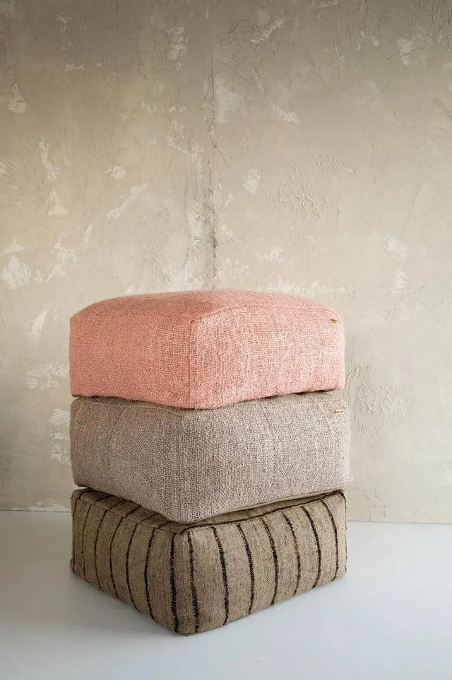 'The Oh My Gee' Pouffe placed in a covered outdoor setting, blending functionality with bohemian charm.