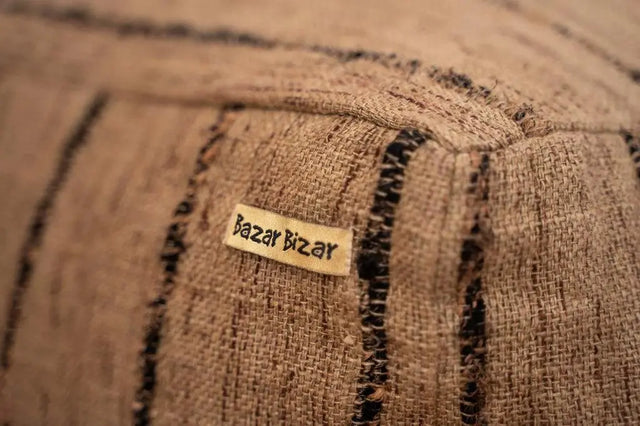 Detailed view of the hand-dyed pattern and stitching on 'The Oh My Gee' Pouffe in beige and black.