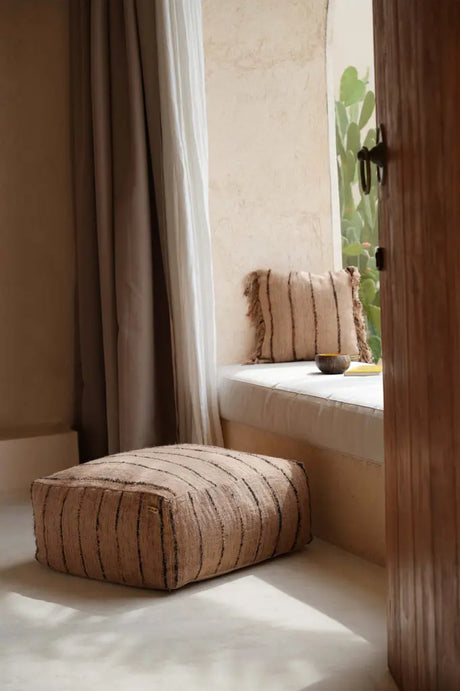 'The Oh My Gee' Pouffe styled as a cozy seating option in a neutral-toned room, emphasizing its versatility and charm.