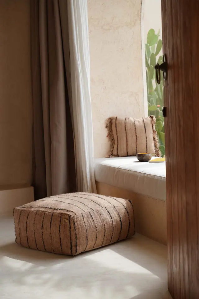 'The Oh My Gee' Pouffe styled as a cozy seating option in a neutral-toned room, emphasizing its versatility and charm.