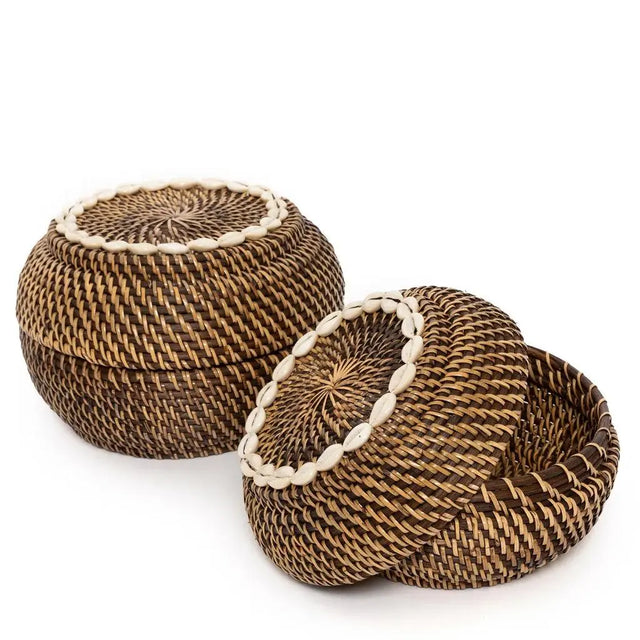 The Colonial Peek-a-Boo Rattan Basket, featuring a timeless design with cowrie shell embellishments, elevates any decor while offering practical storage solutions.