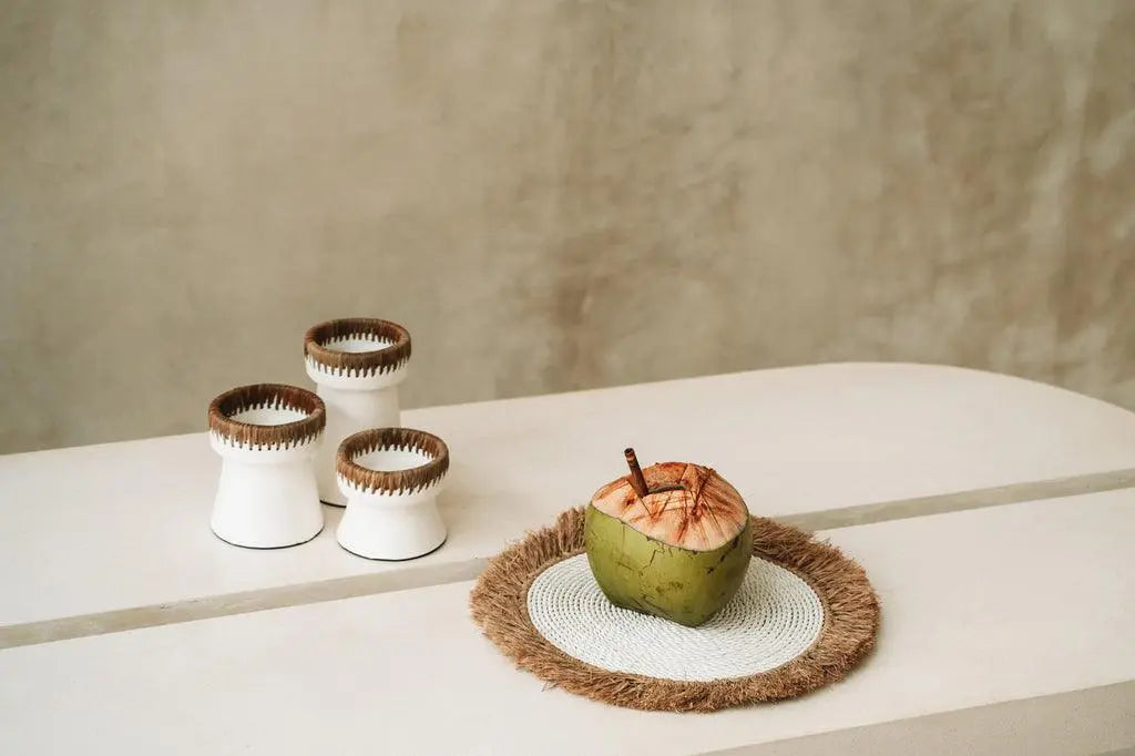 Refined white terracotta candle holder with a touch of raffia detailing for added sophistication