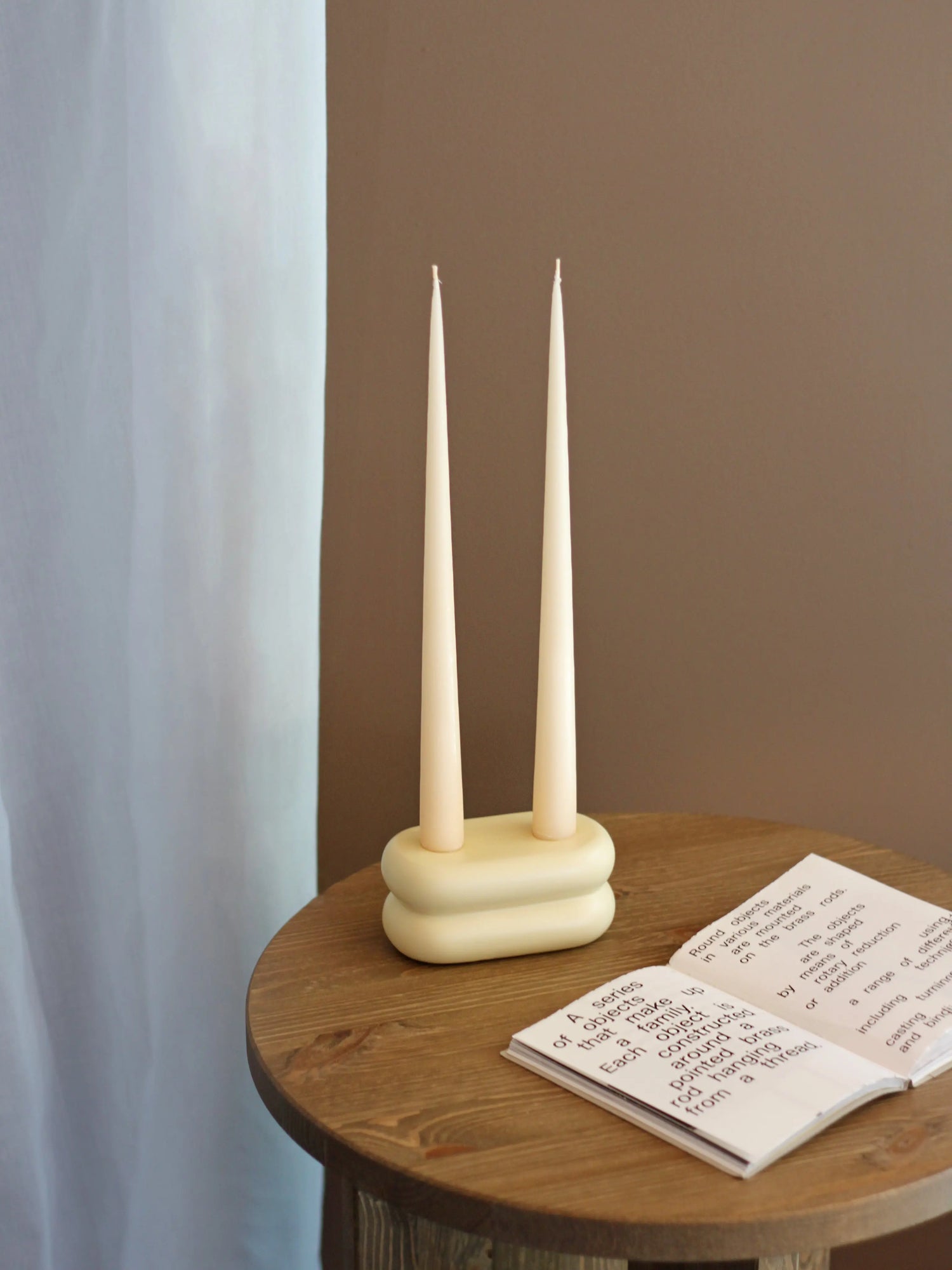 Playful yet elegant matte pastel yellow ceramic candlestick with rounded curves, perfect for modern decor