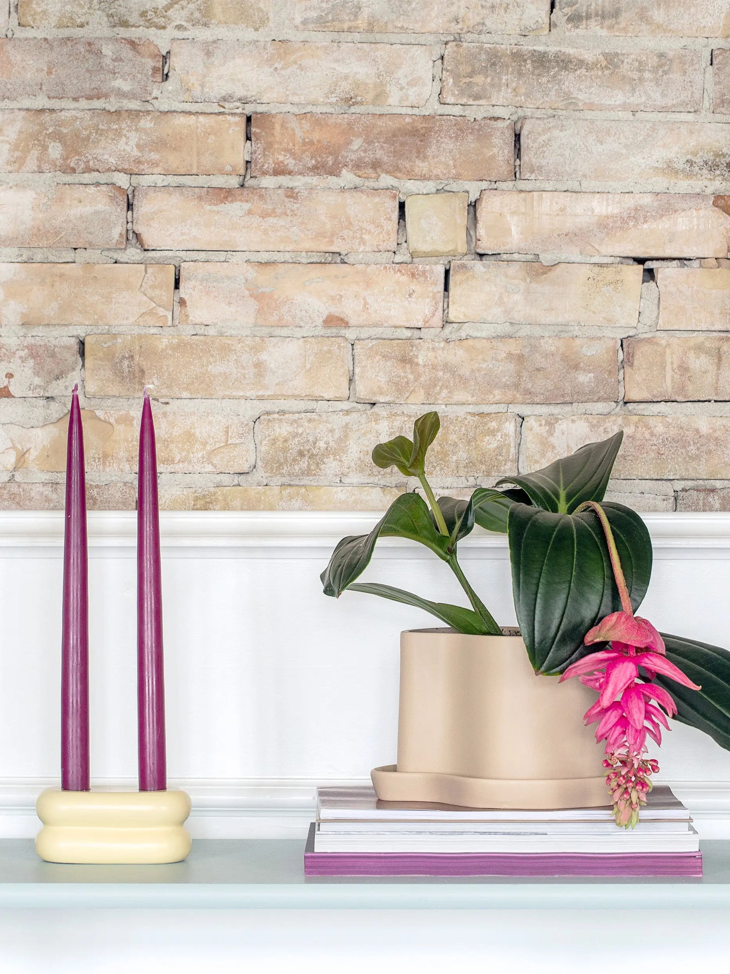 Soft pastel yellow ceramic candlestick designed for versatile styling with other colorful or neutral decor