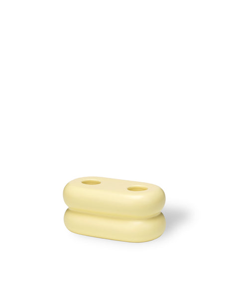 Versatile ceramic candlestick with a soft pastel yellow glaze, designed to hold two candles for stylish lighting