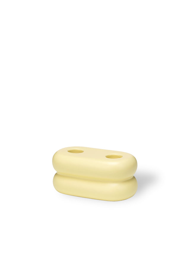 Versatile ceramic candlestick with a soft pastel yellow glaze, designed to hold two candles for stylish lighting