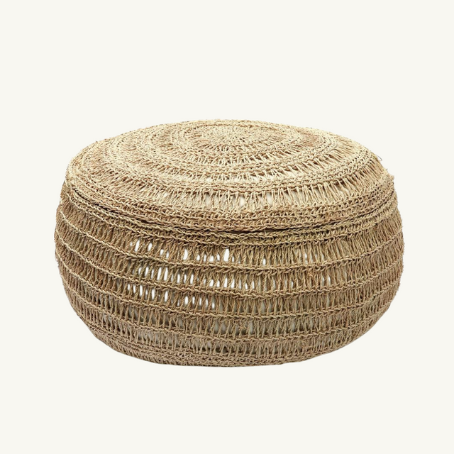 Eco-friendly round pouffe made from handwoven seagrass, perfect for boho-chic living rooms or outdoor spaces