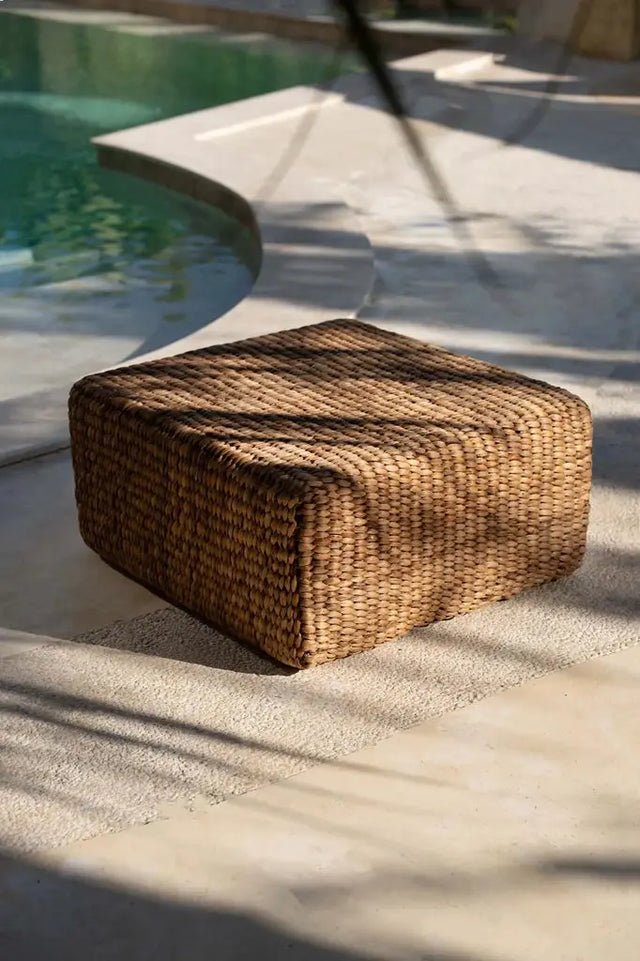 Versatile natural hyacinth pouffe, ideal for extra seating, footrest, or a decorative accent piece, with a unique handwoven design