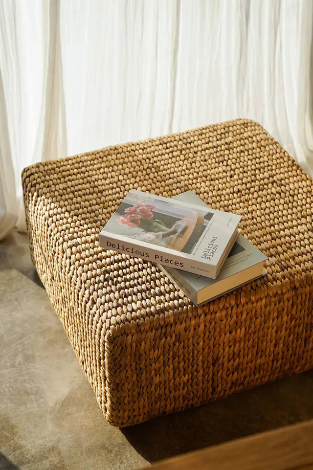 Unique, handwoven hyacinth pouffe with natural variations, perfect for adding bohemian style to modern or rustic interiors
