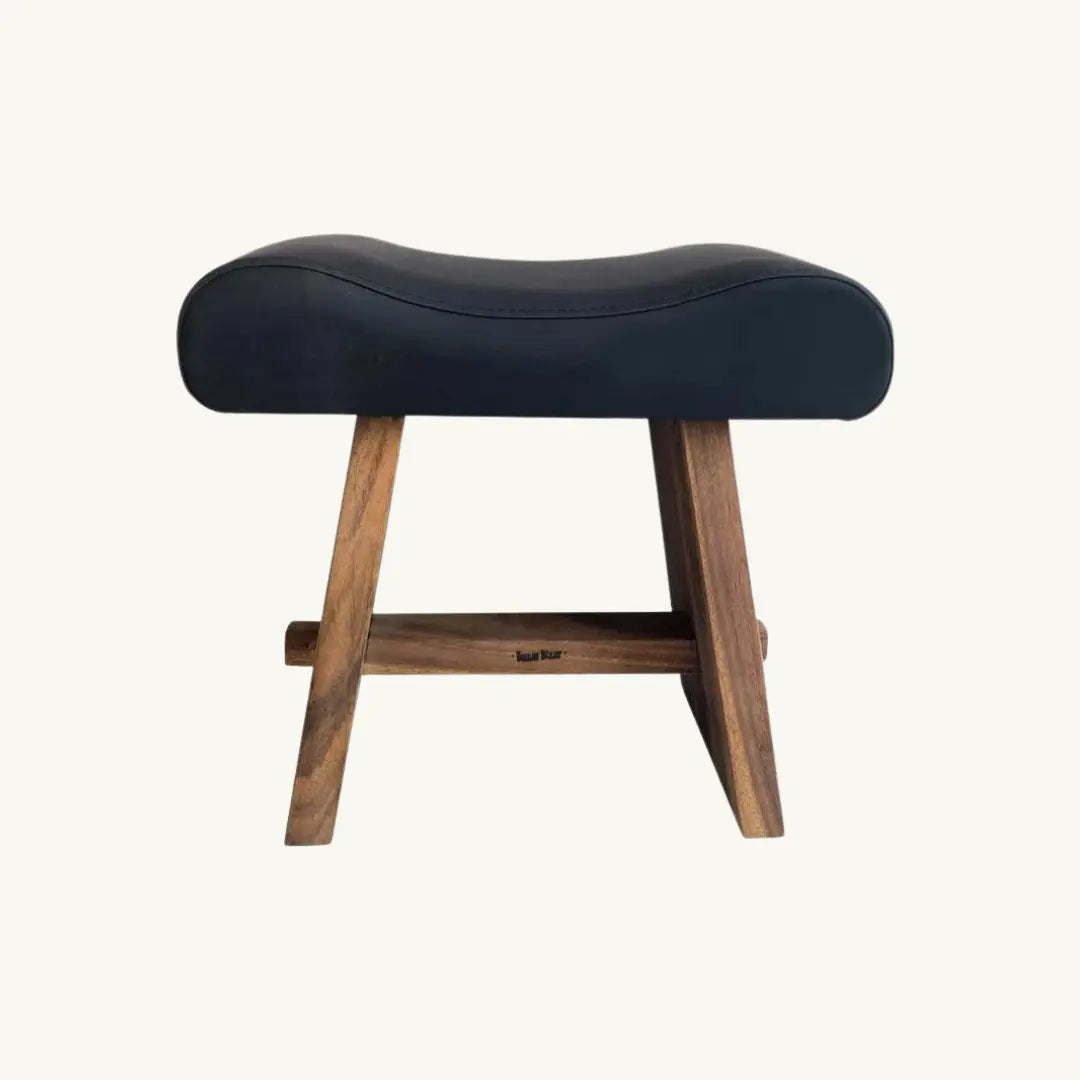 Minimalist stool crafted from suar wood and black leather, ideal for adding modern elegance to any living space