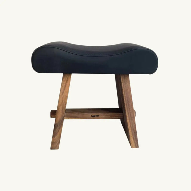 Minimalist stool crafted from suar wood and black leather, ideal for adding modern elegance to any living space