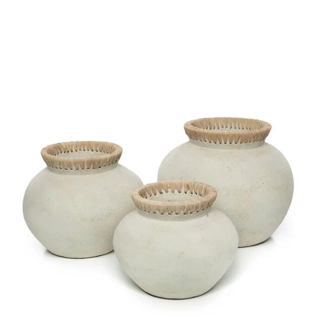 This terracotta 'Styly' Vase, with its rattan detailing, adds a touch of coastal elegance and is perfect for dried flower displays