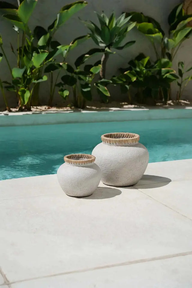 Infuse coastal elegance into your decor with the 'Styly' Vase, made from terracotta and decorated with stylish rattan details