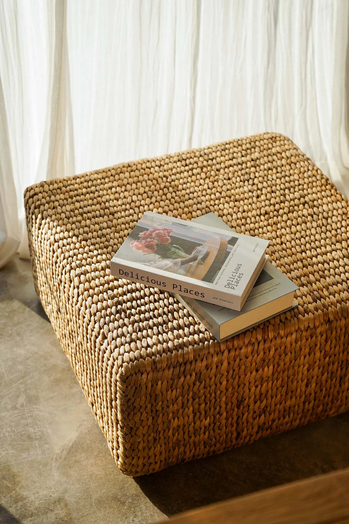 Unique, handwoven hyacinth pouffe with natural variations, perfect for adding bohemian style to modern or rustic interiors