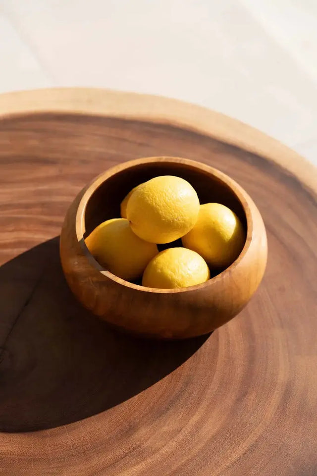 Unique fruit bowl made from sustainably sourced teak root, with a rustic charm and natural hues perfect for any modern kitchen or dining room.