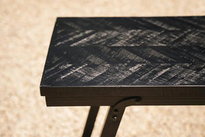 Stylish teakwood dining table with a refined herringbone pattern, complemented by a durable black iron frame for added elegance and stability.