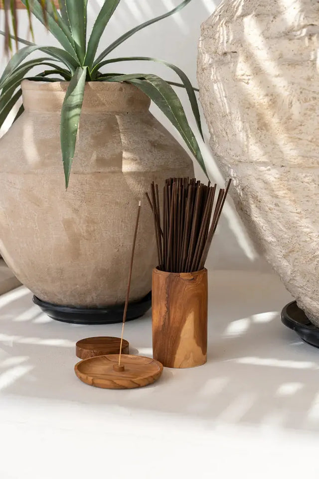 Handcrafted teak wood pot with distinctive natural textures and organic contours, each piece showcasing unique craftsmanship and elegance.