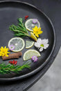 Add a touch of elegance to your table with this black burnt terracotta plate. Durable and food-safe, it's perfect for hosting meals in style. Dishwasher safe for easy cleaning.