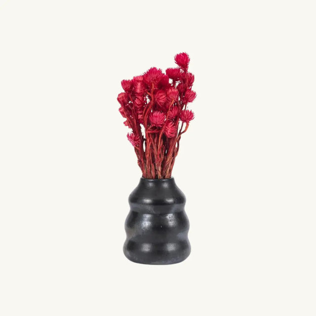 This sleek black terracotta vessel is perfect as a vase for dried flowers or as a stylish utensil holder. Food-safe and a beautiful addition to your kitchen or table.