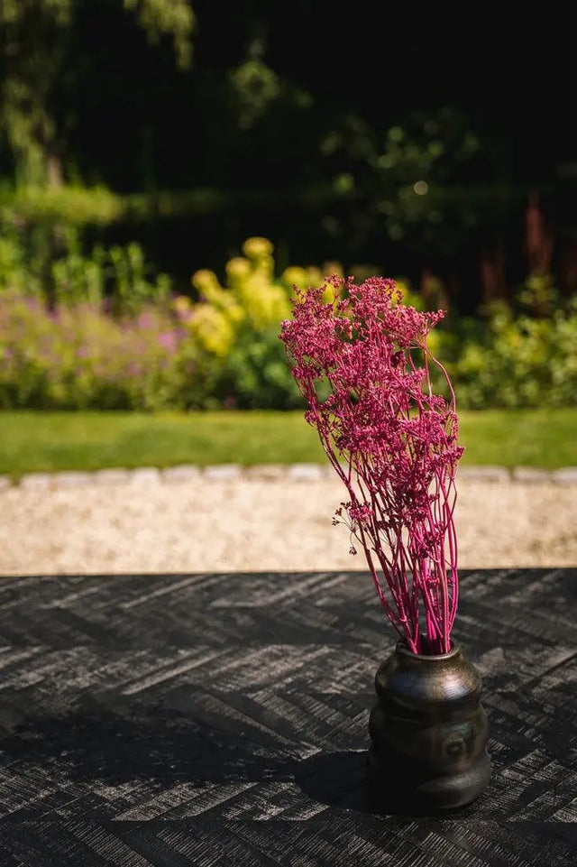 Enhance your kitchen or table with this elegant black terracotta vessel. Use it for dried flowers or as a utensil holder, adding style to any home while being food-safe.