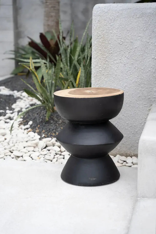 Add sophistication to your space with the Kulun Stool. Handcrafted from high-quality Suar wood, its modern black finish complements contemporary decor.
