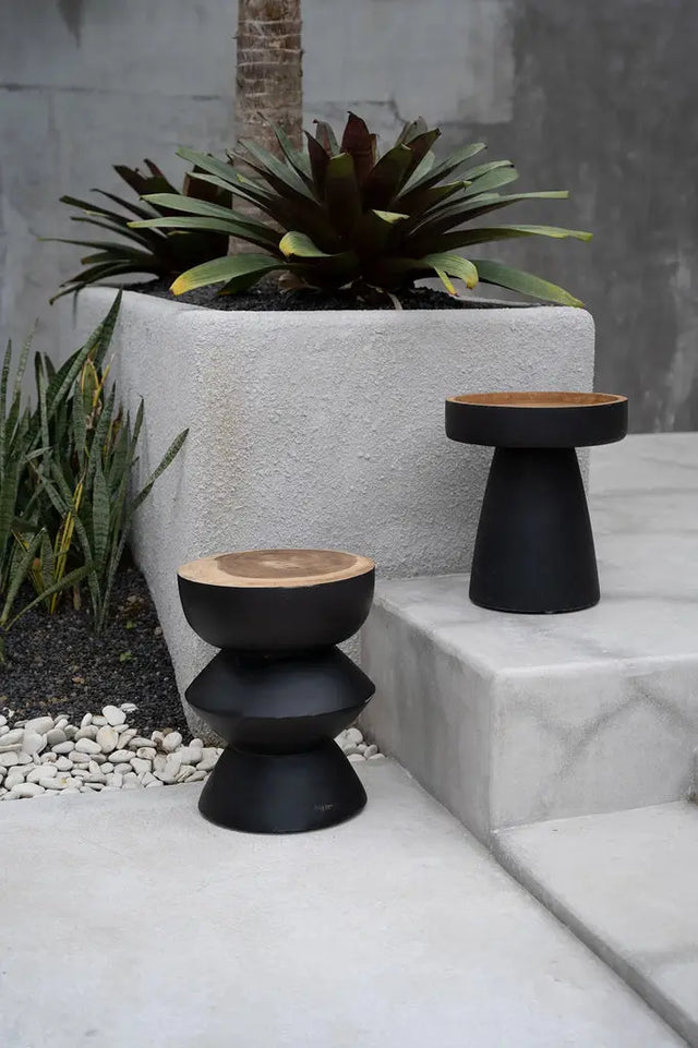 The Kulun Stool is a versatile addition to any room. Crafted from durable Suar wood, it features a modern black finish, perfect for both indoor and covered outdoor areas.