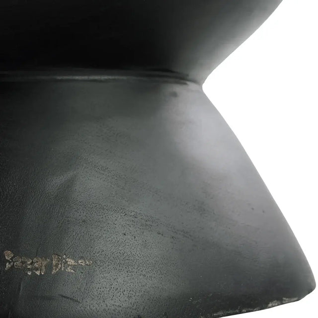 Add contemporary charm to your space with the Kulun Stool. Handcrafted from natural Suar wood, it features a sleek black finish perfect for modern decor.